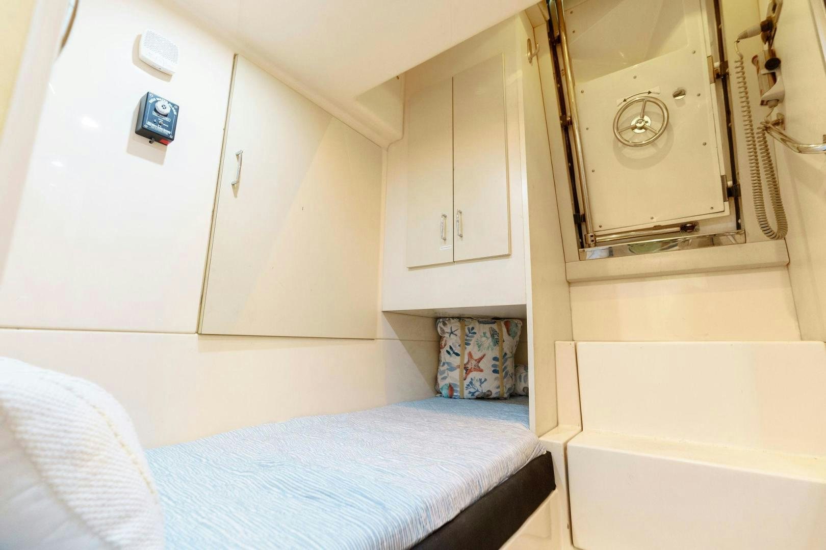 a small room with a bed and a washing machine aboard LA BELLA VITA Yacht for Sale