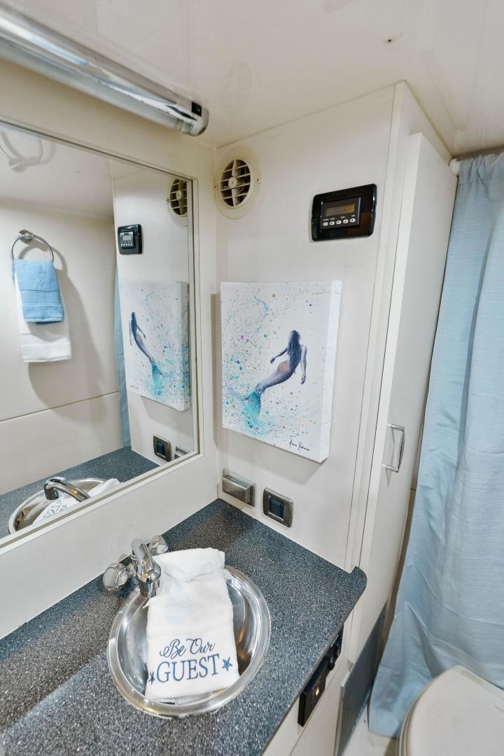 a bathroom with a blue curtain aboard LA BELLA VITA Yacht for Sale