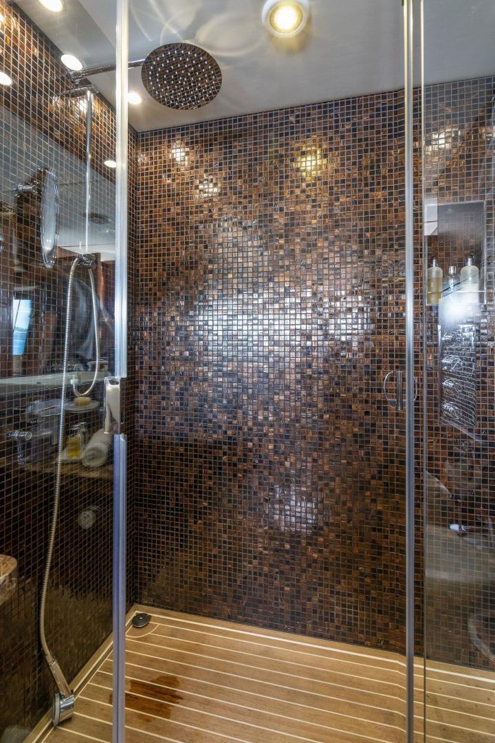 a large glass wall with a circular object on it aboard 21 SEA SANDS Yacht for Sale