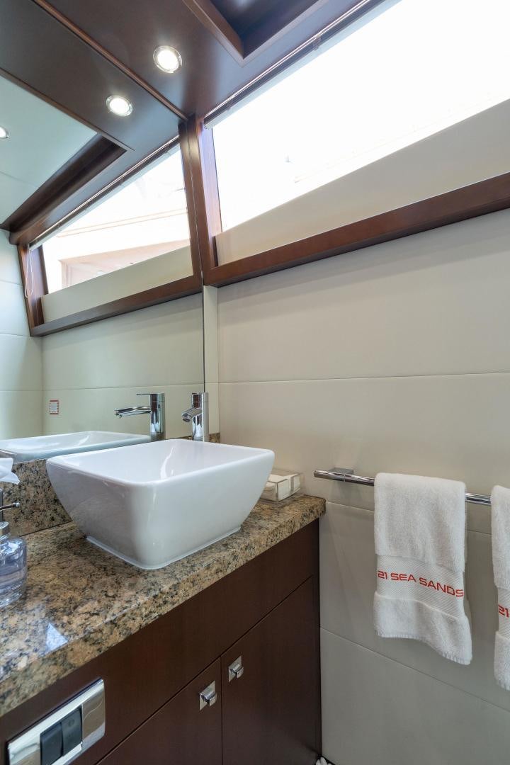 a bathroom with a sink and a mirror aboard 21 SEA SANDS Yacht for Sale