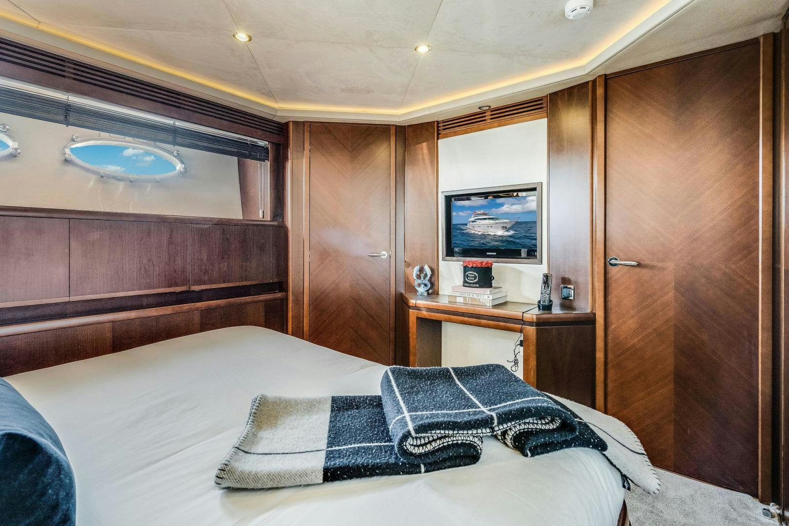 a bedroom with a bed and a television aboard 21 SEA SANDS Yacht for Sale