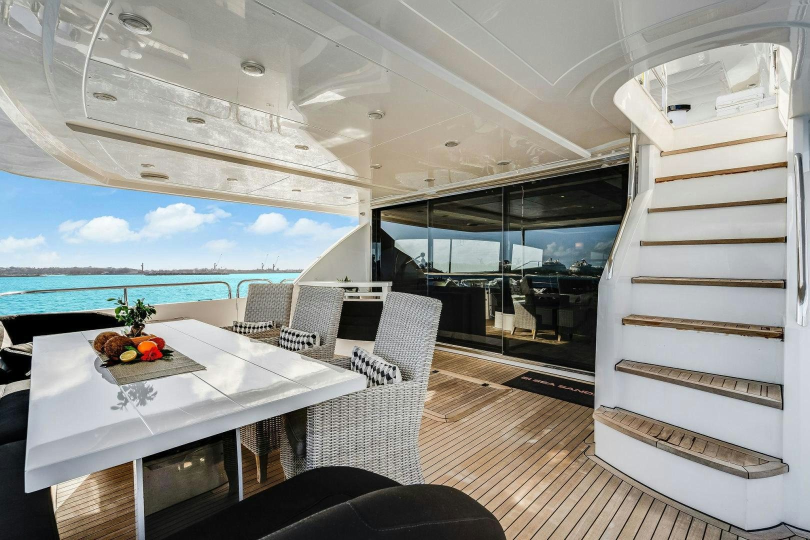 a room with a table chairs and a large window aboard 21 SEA SANDS Yacht for Sale