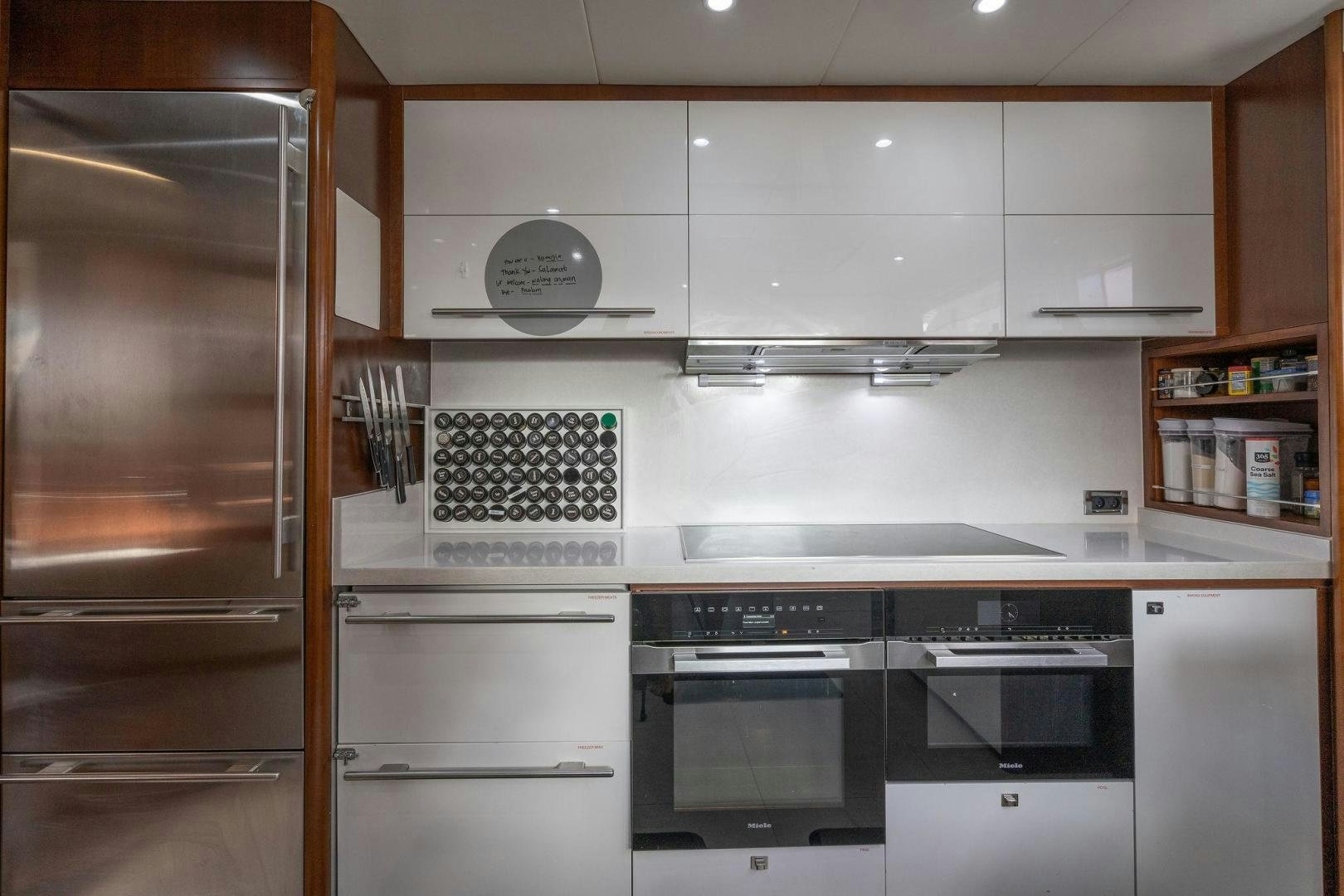 a kitchen with white cabinets aboard 21 SEA SANDS Yacht for Sale
