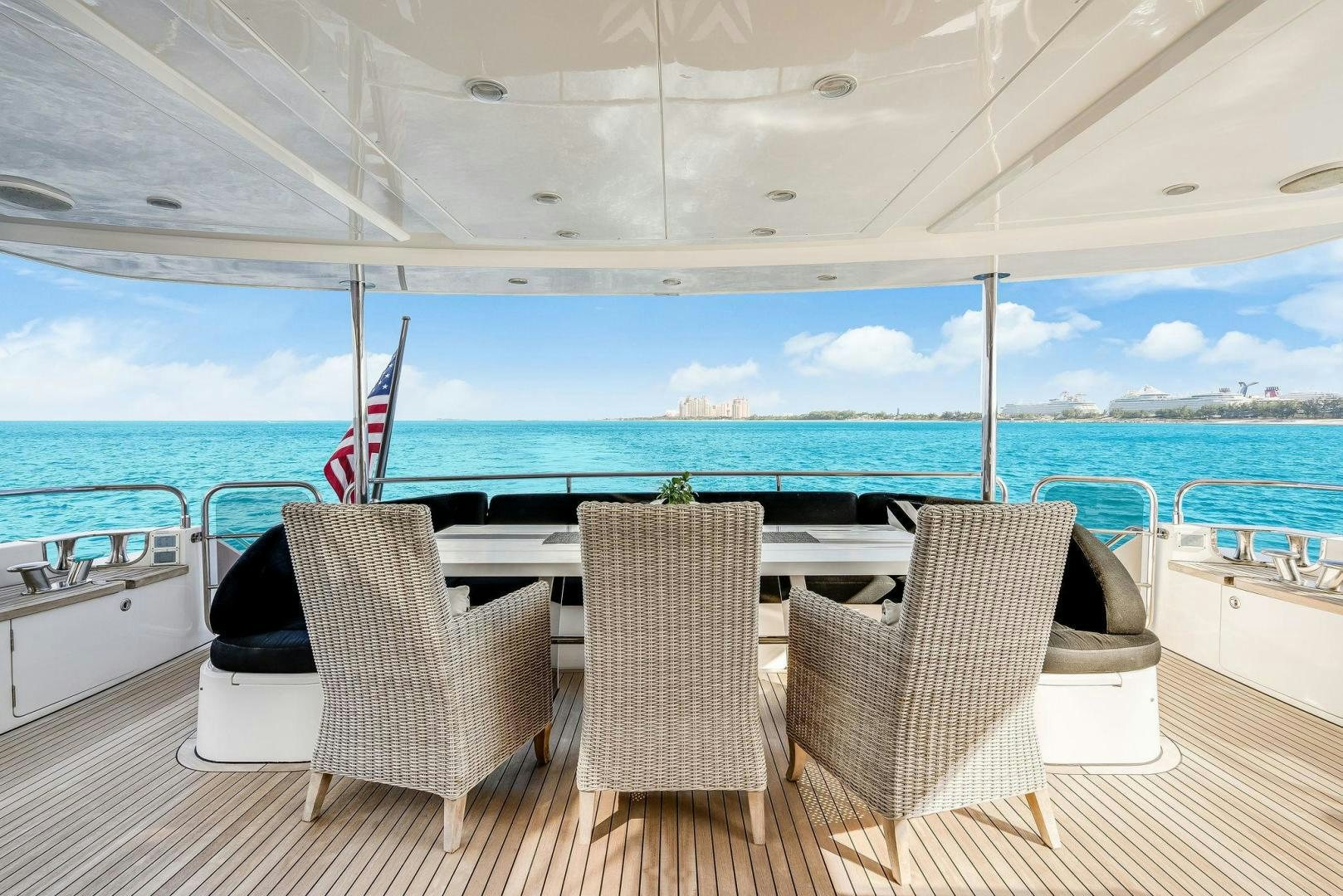 a table and chairs on a deck overlooking a body of water aboard 21 SEA SANDS Yacht for Sale