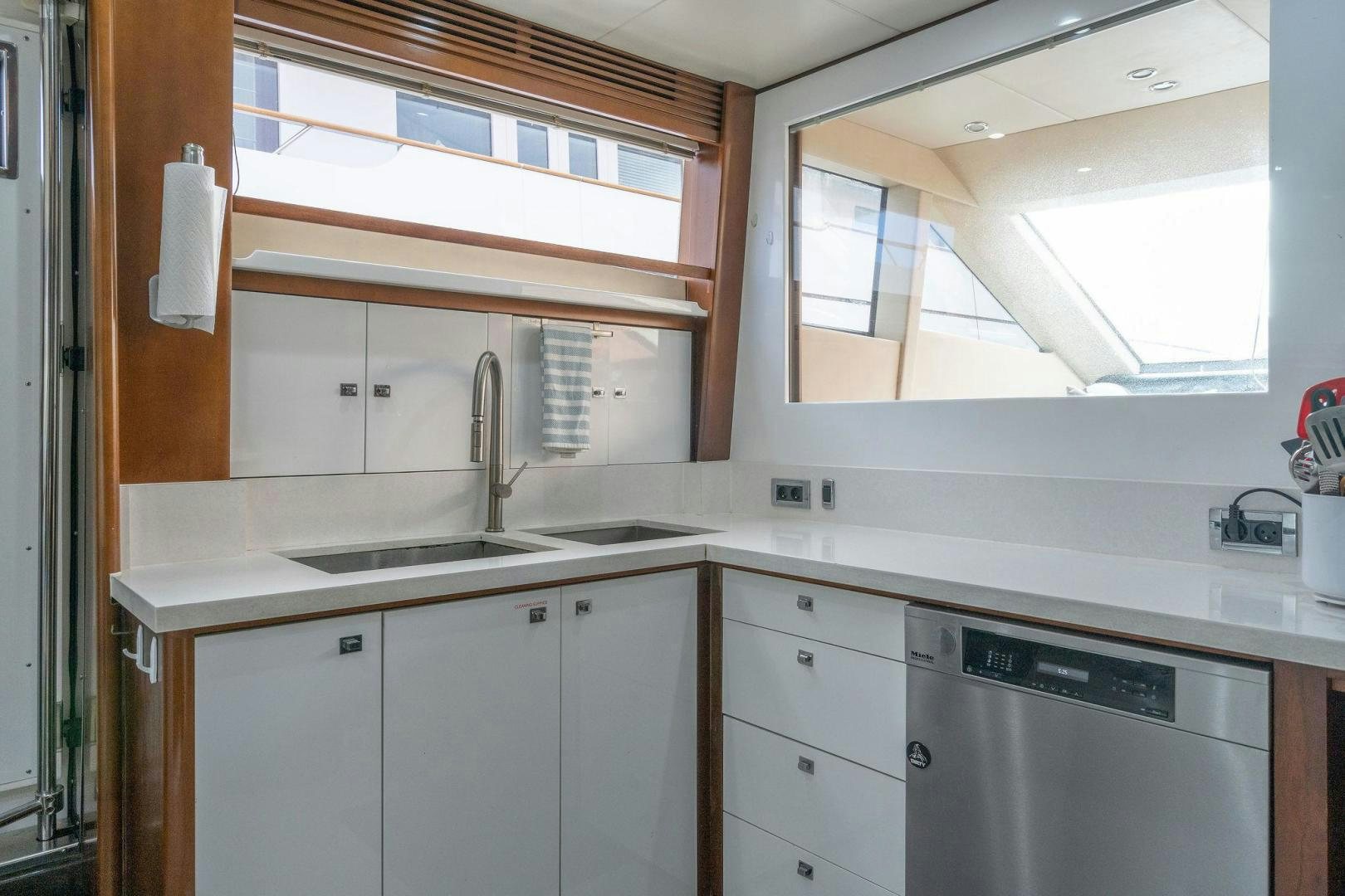 a kitchen with white cabinets aboard 21 SEA SANDS Yacht for Sale