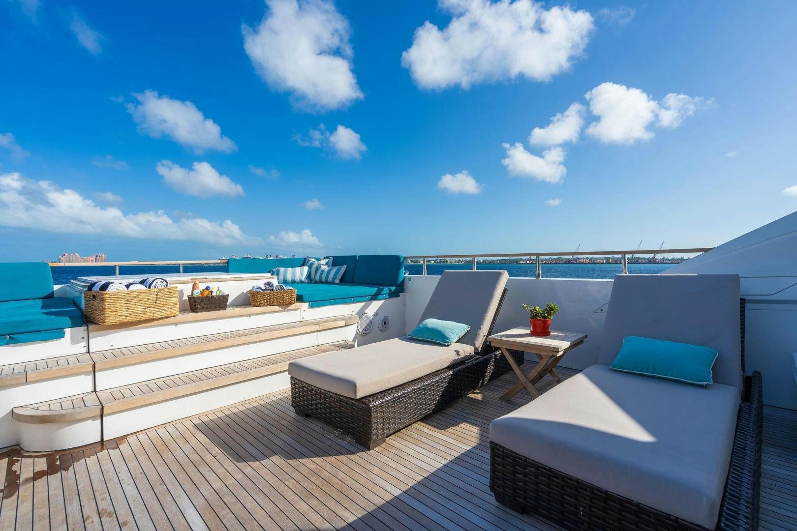 a balcony with a table and chairs aboard 21 SEA SANDS Yacht for Sale