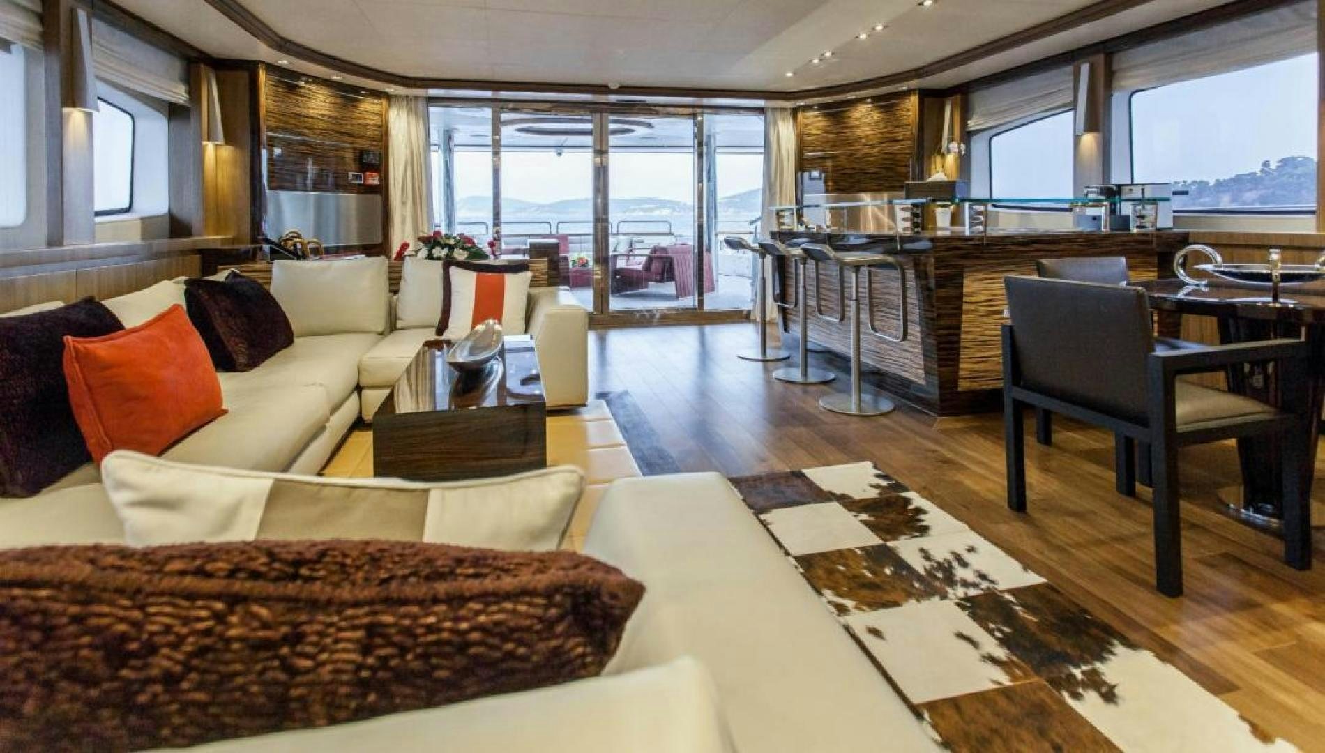 a living room with a large window aboard PANAKEIA Yacht for Charter