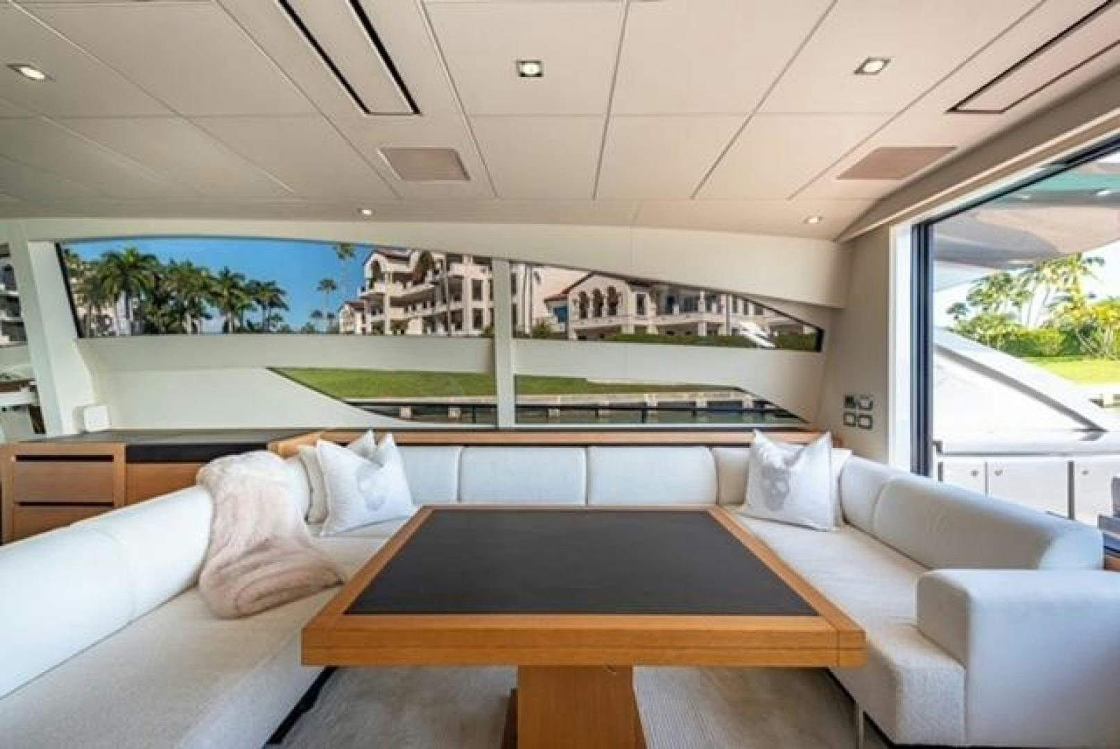 a room with a table and couch aboard RAW 2 Yacht for Sale