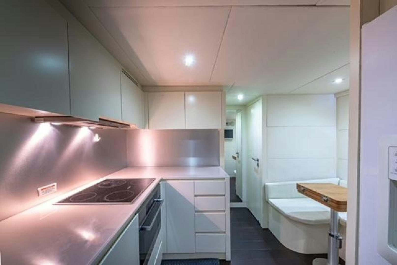 a kitchen with pink cabinets aboard RAW 2 Yacht for Sale