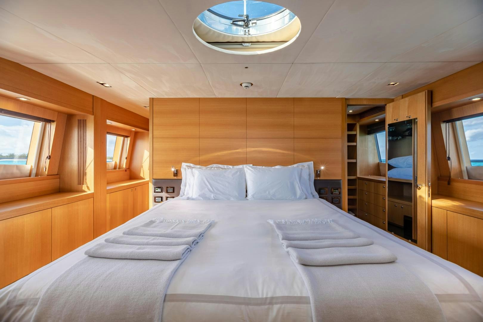 a bed with white sheets aboard CORAZON Yacht for Sale