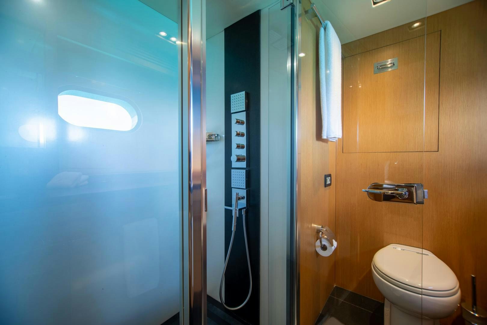 a bathroom with a toilet and a shower unit aboard CORAZON Yacht for Sale