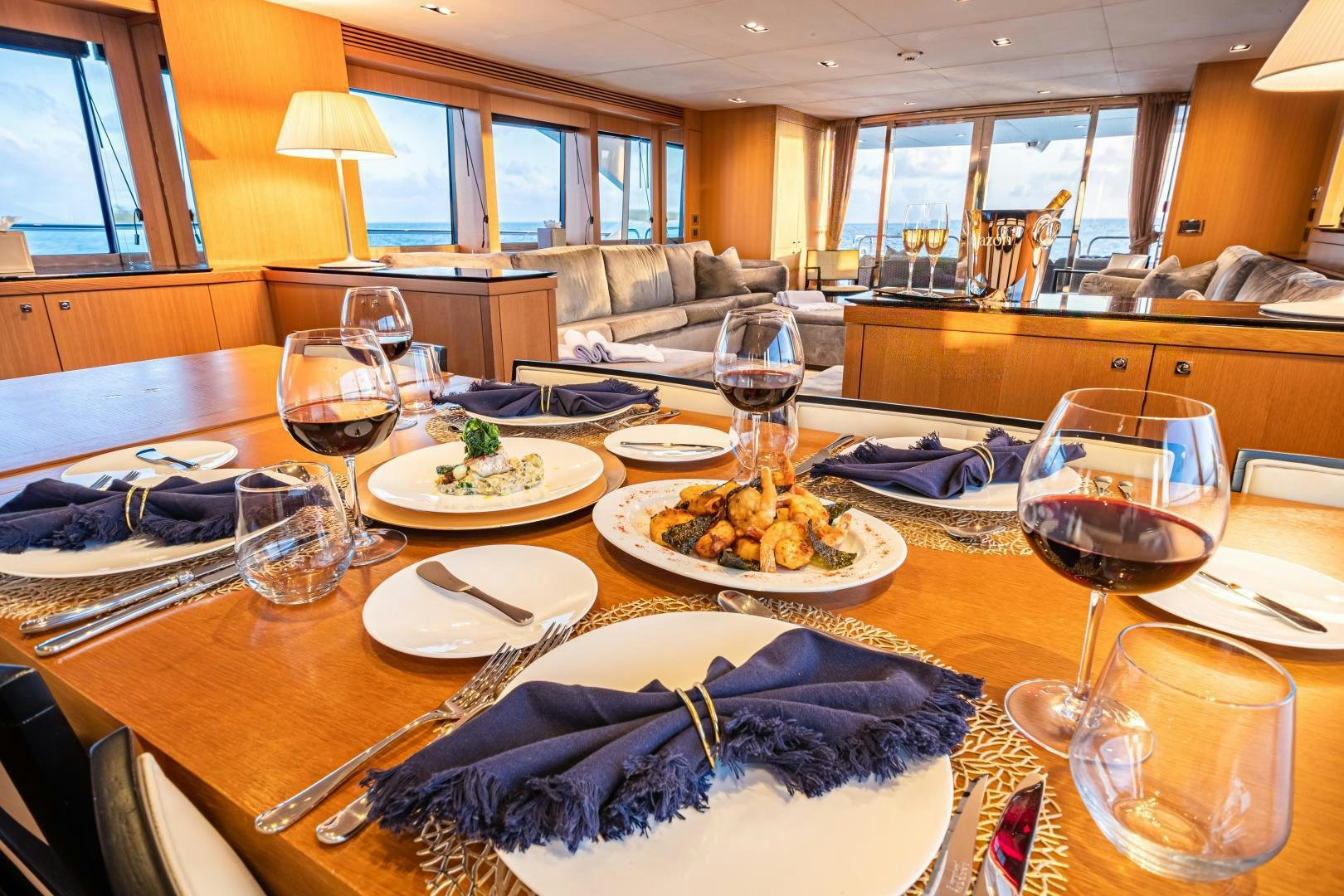 a large dining table with plates and glasses on it aboard CORAZON Yacht for Sale