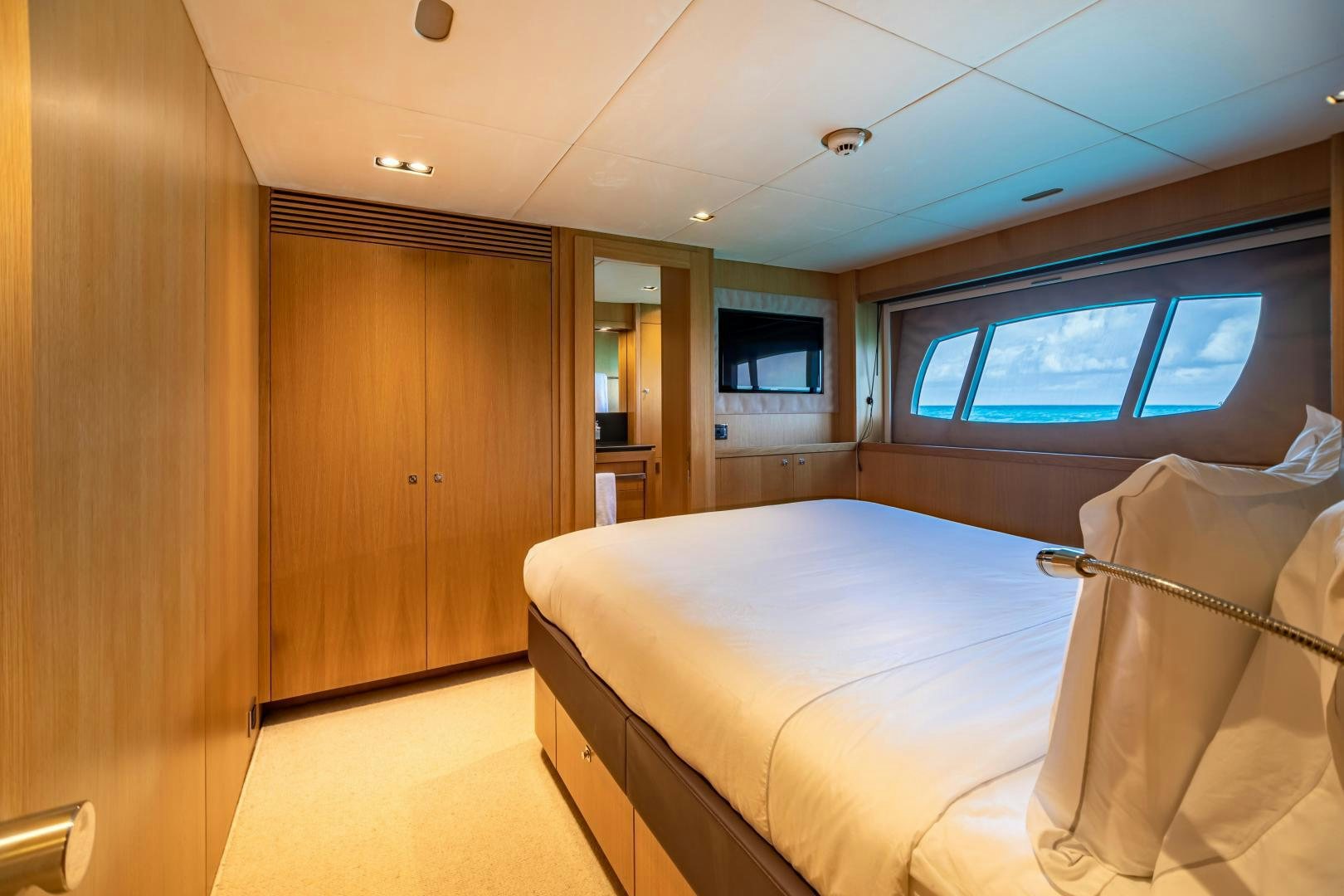 a room with a bed and a window aboard CORAZON Yacht for Sale