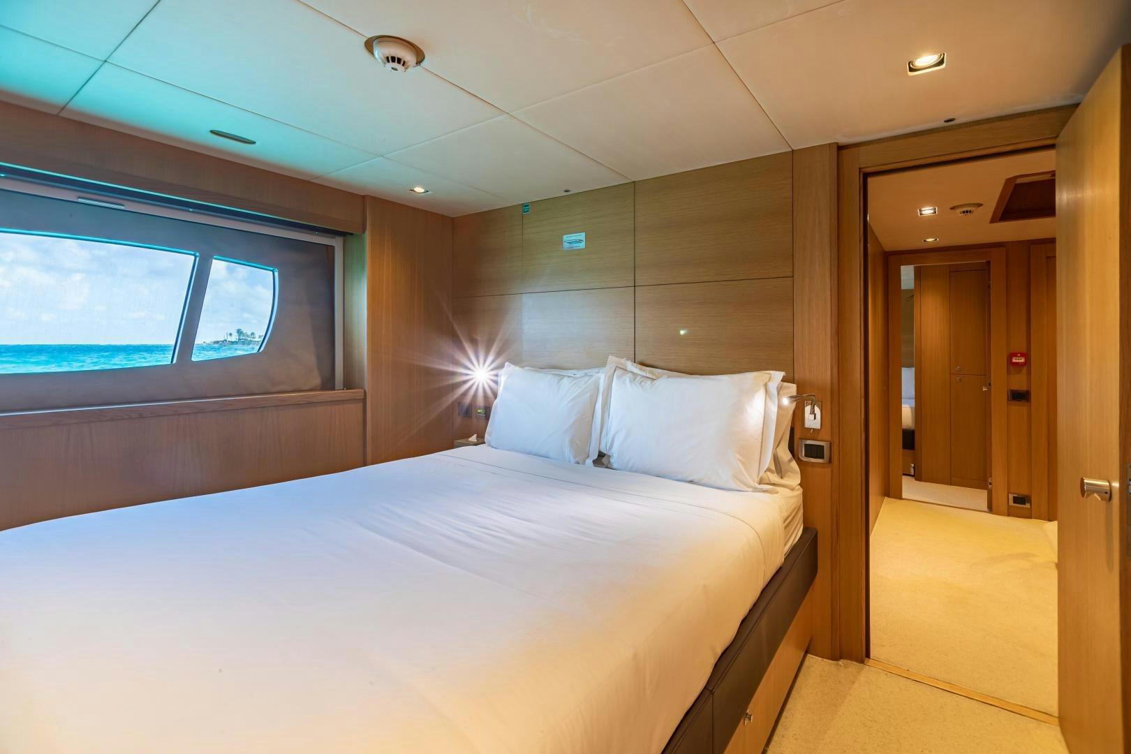 a room with a bed and a window aboard CORAZON Yacht for Sale