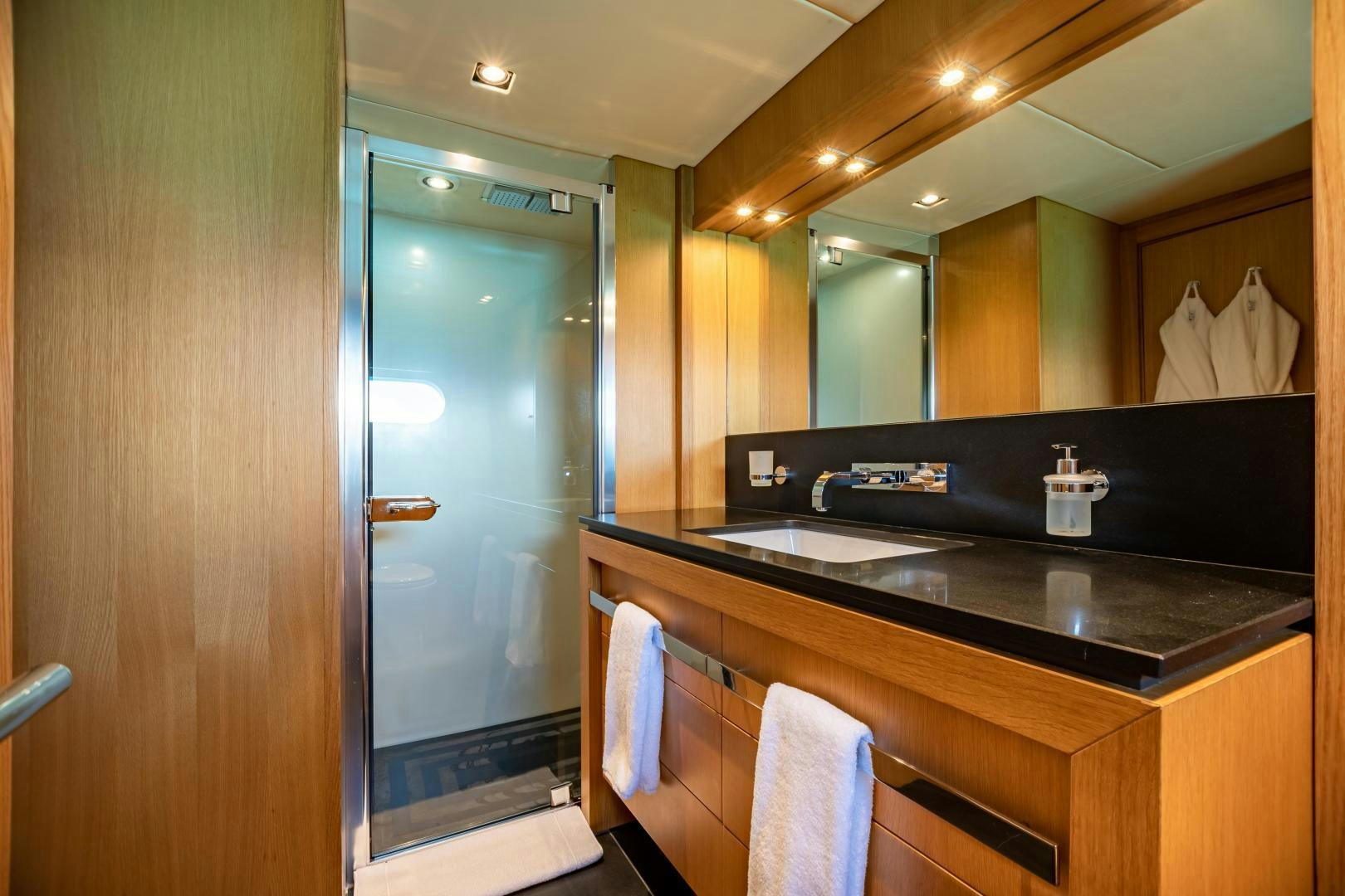 a bathroom with a large mirror aboard CORAZON Yacht for Sale
