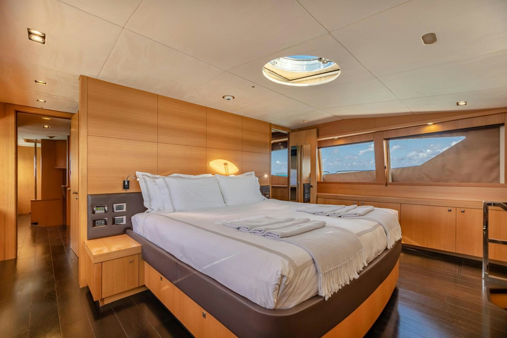 a room with a bed and a desk aboard CORAZON Yacht for Sale