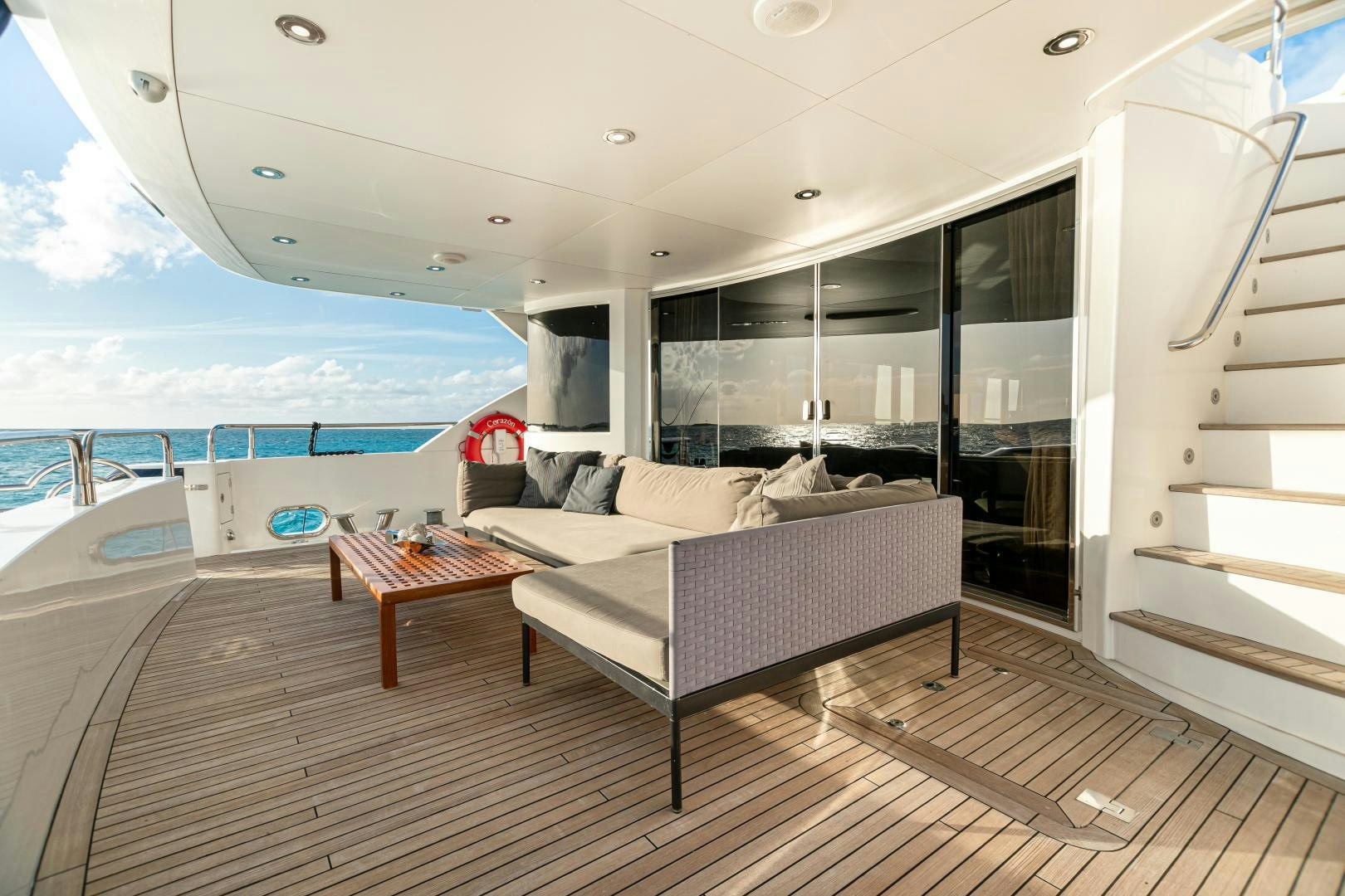 a living room with a couch and a table aboard CORAZON Yacht for Sale