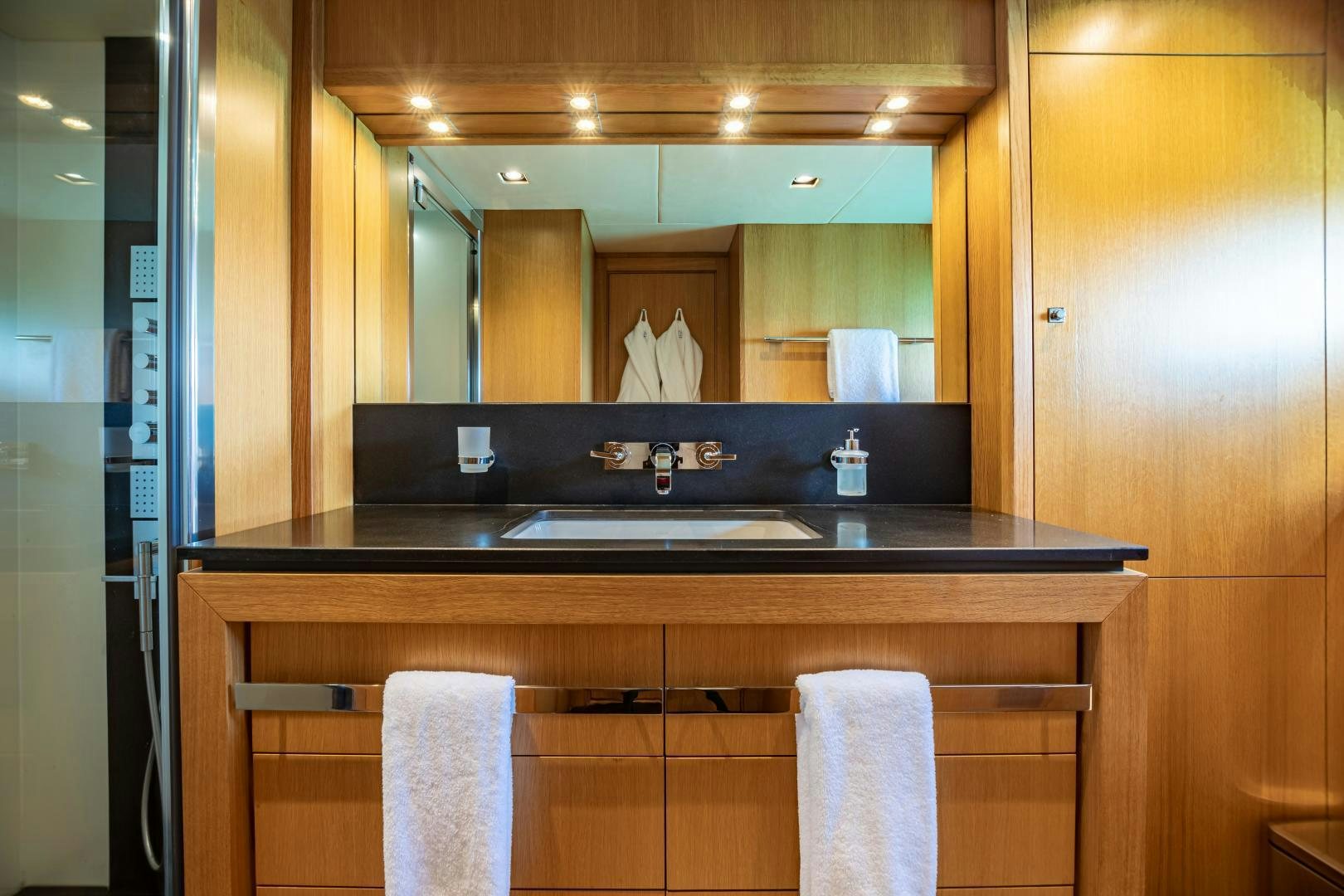 a bathroom with a large mirror aboard CORAZON Yacht for Sale
