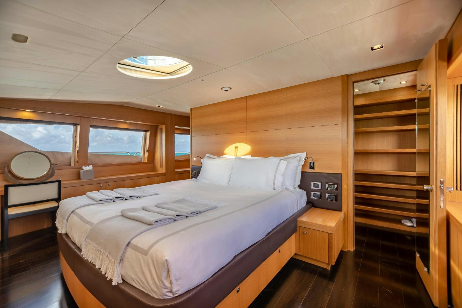 a room with a bed and a mirror aboard CORAZON Yacht for Sale