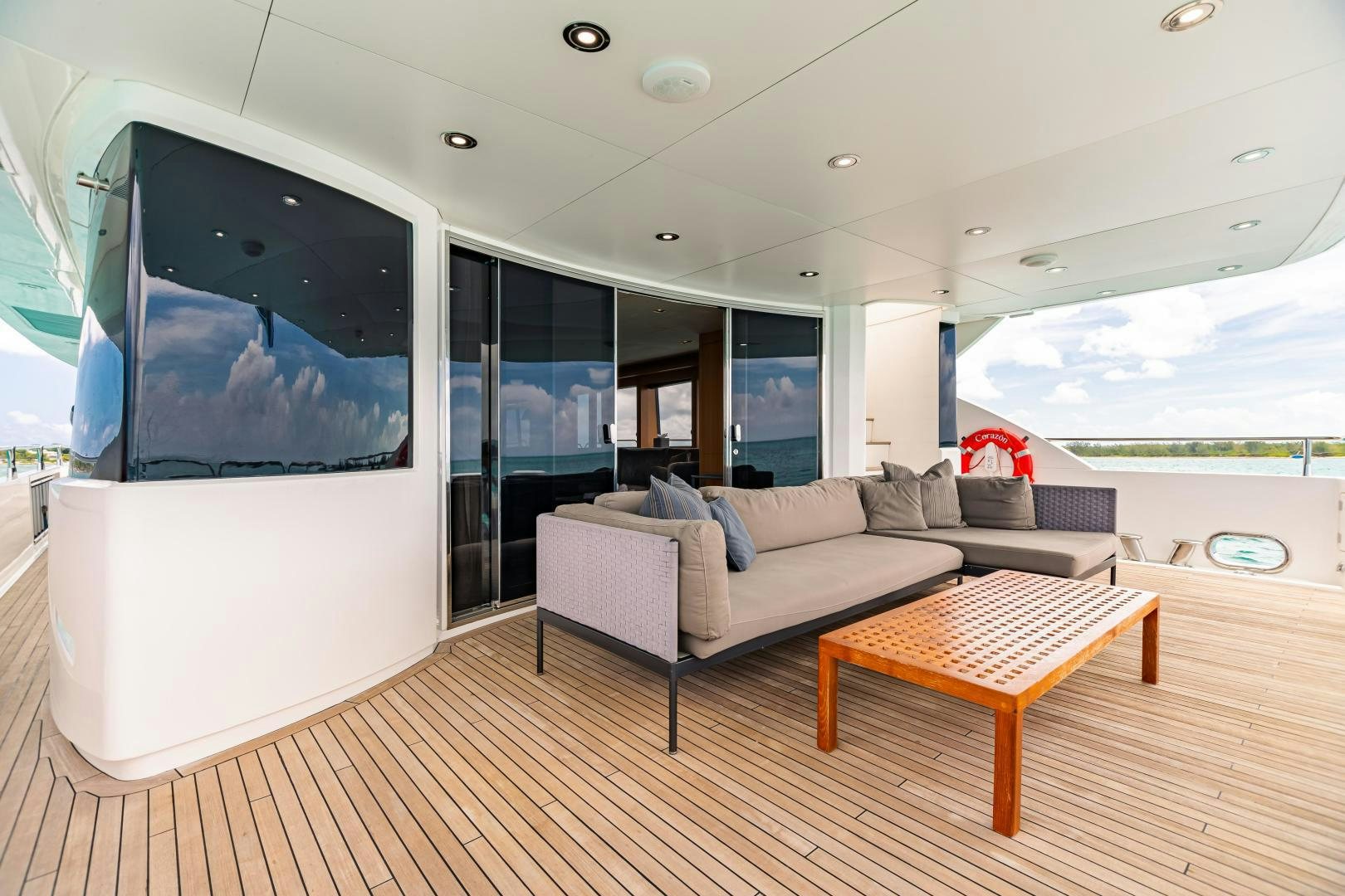 a living room with a large screen aboard CORAZON Yacht for Sale