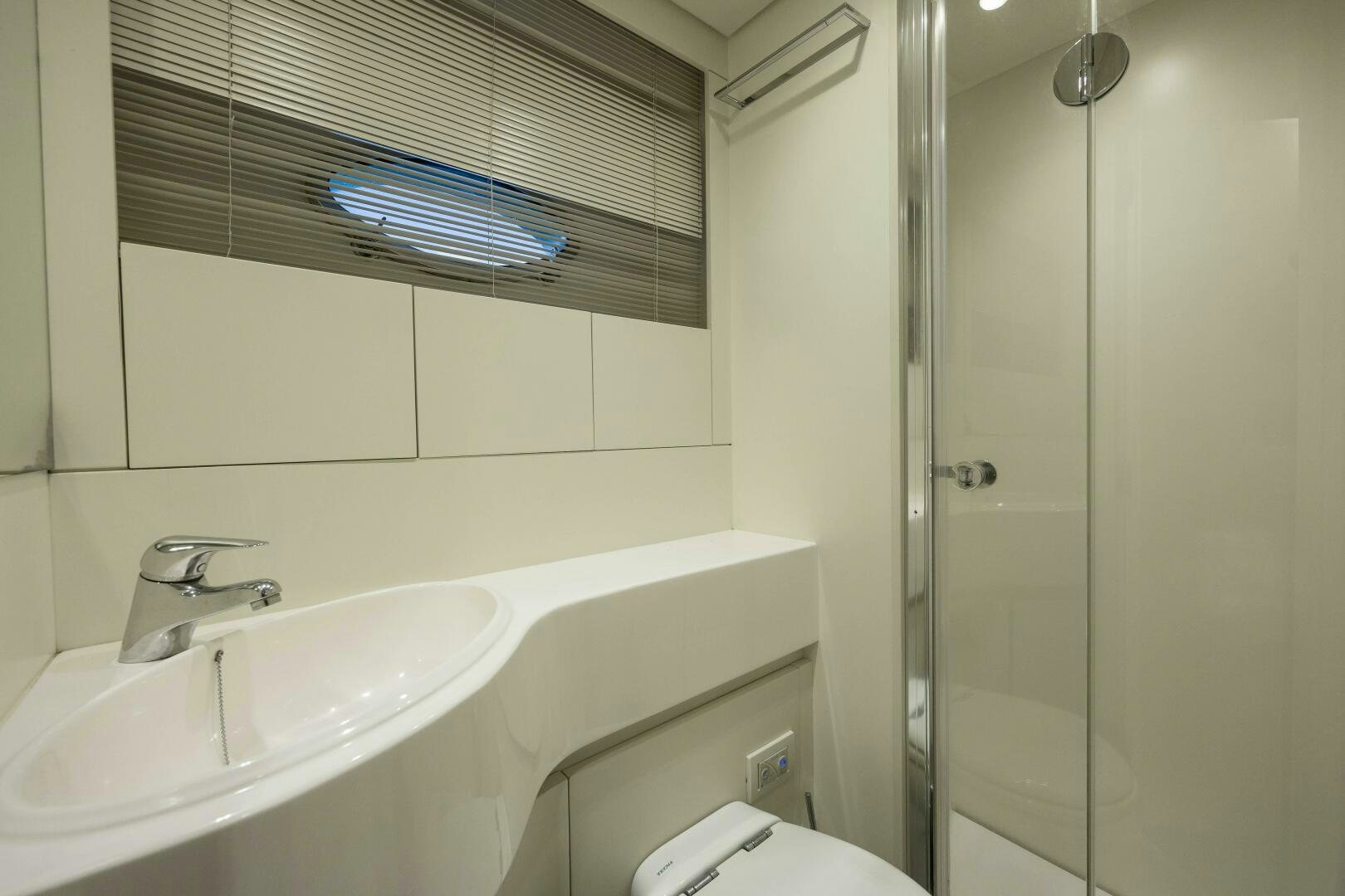 a bathroom with a sink and a shower aboard MILAGROS Yacht for Sale