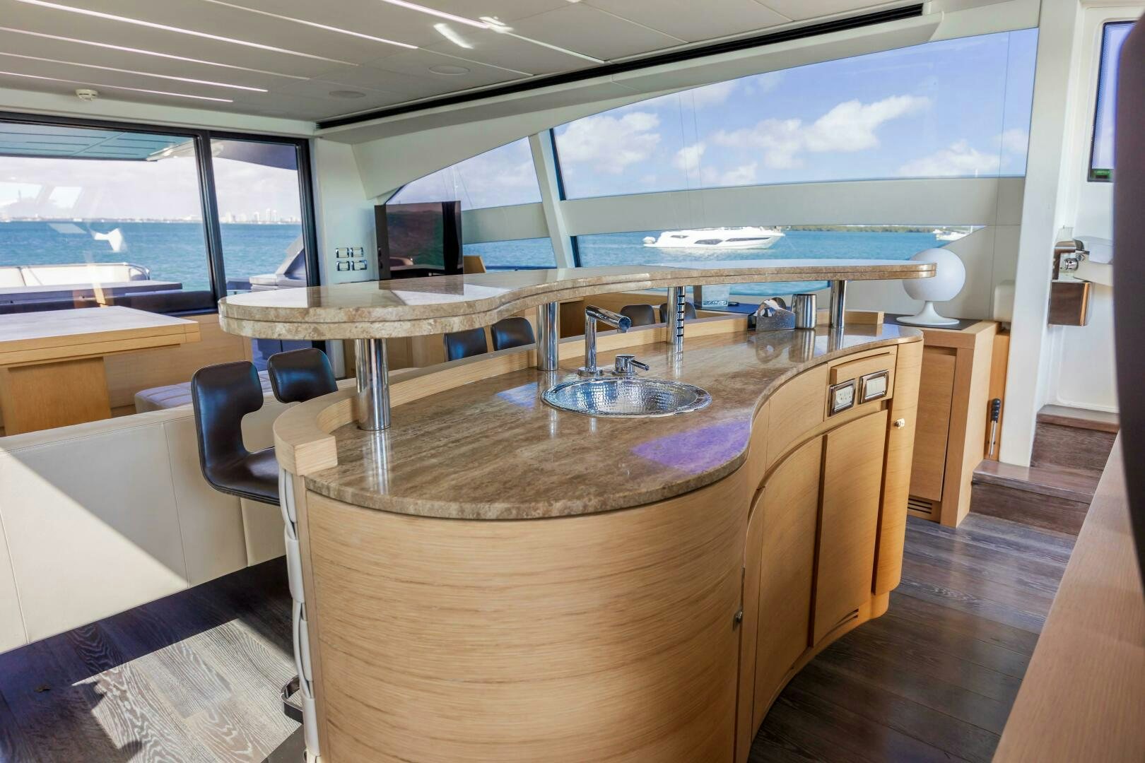 a large room with a table and chairs aboard MILAGROS Yacht for Sale