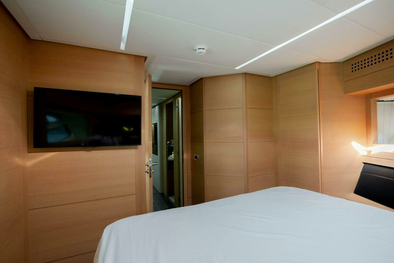 a room with a bed and a television aboard MILAGROS Yacht for Sale