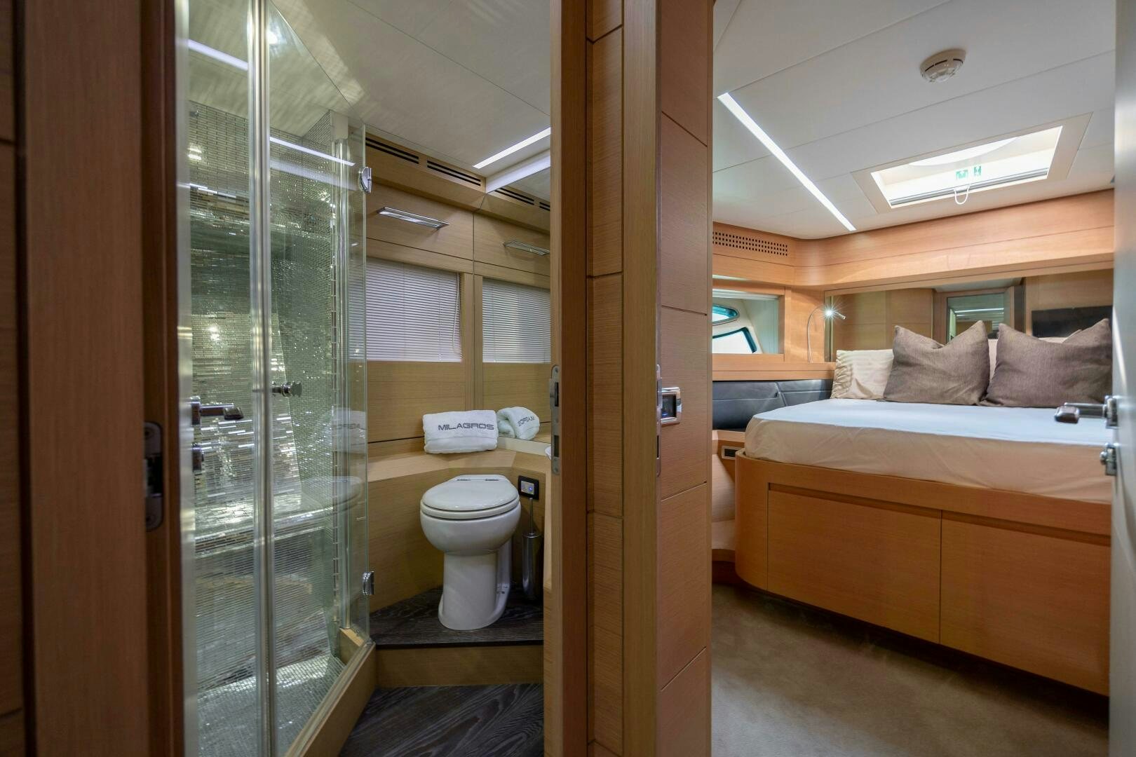 a bathroom with a glass shower aboard MILAGROS Yacht for Sale
