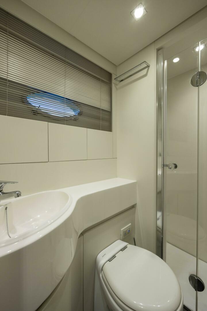 a bathroom with a shower sink and toilet aboard MILAGROS Yacht for Sale