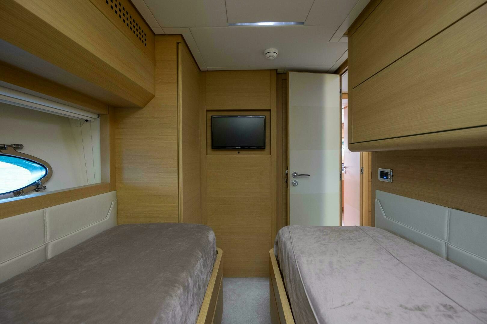 a room with a bed and a tv on the wall aboard MILAGROS Yacht for Sale