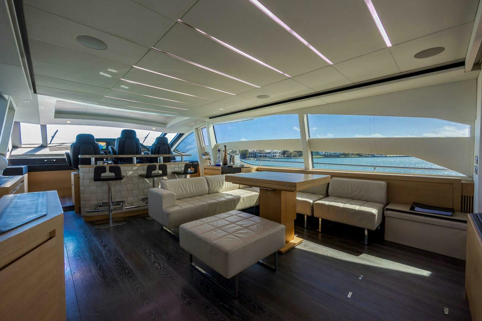 a room with a couch and a table and a view of the water aboard MILAGROS Yacht for Sale