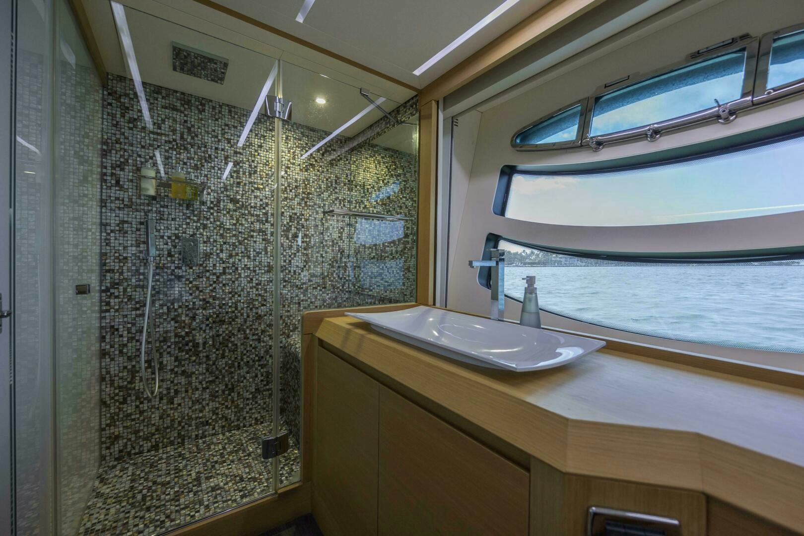 a bathroom with a sink and a shower aboard MILAGROS Yacht for Sale