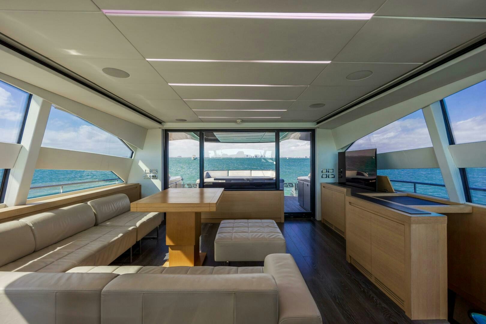 a room with a couch and a table and a tv aboard MILAGROS Yacht for Sale