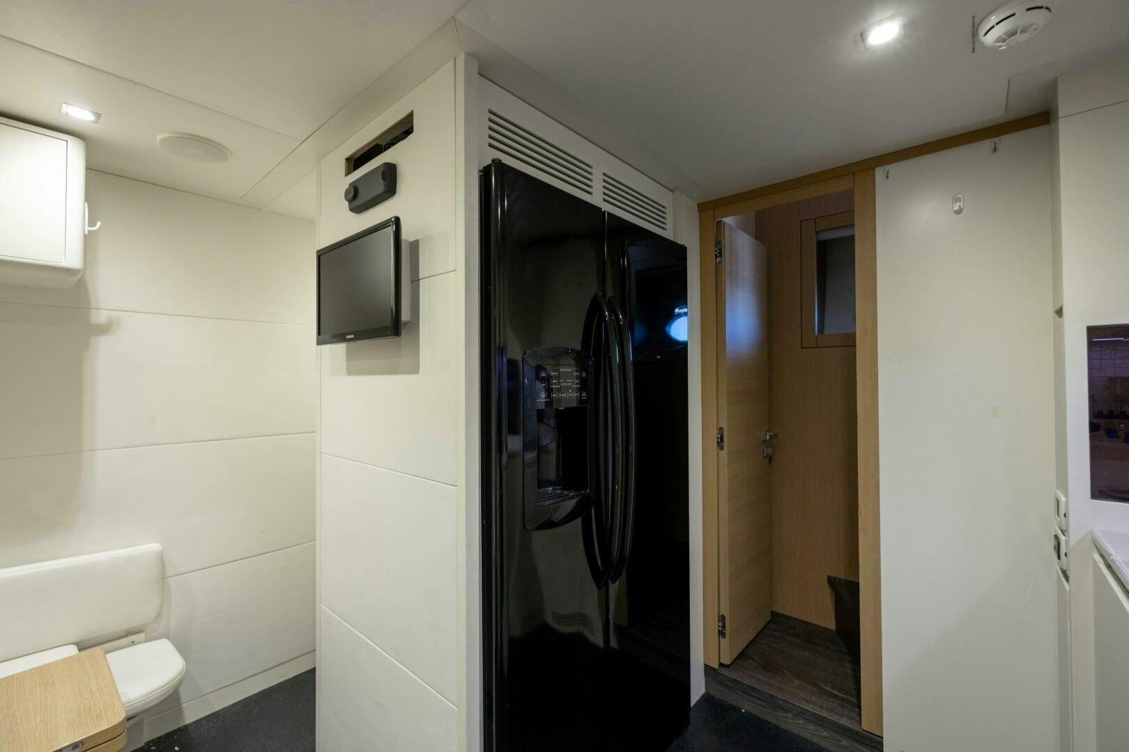 a room with a door and a tv on the wall aboard MILAGROS Yacht for Sale