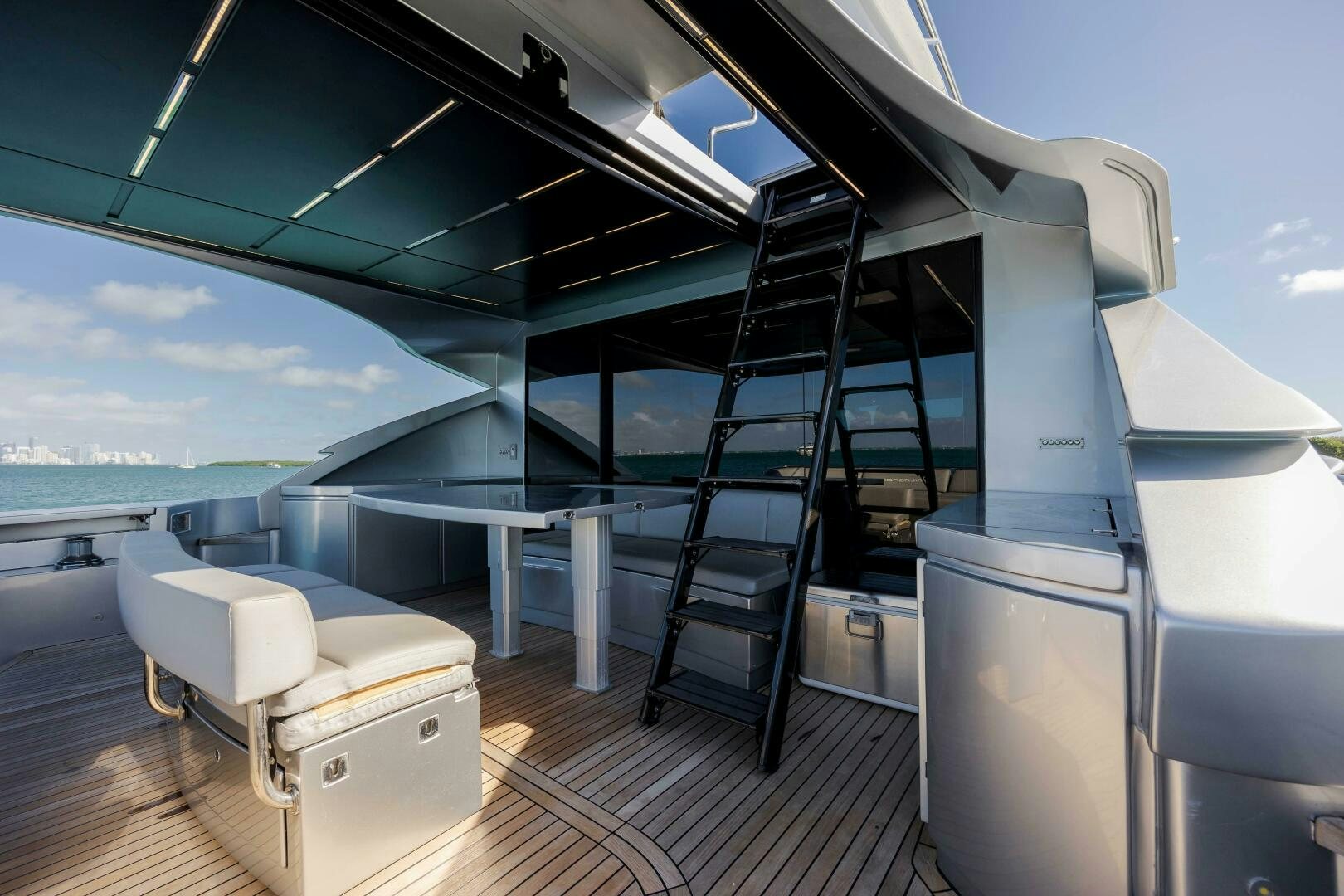 a room with a large window and a white couch and a white chair aboard MILAGROS Yacht for Sale