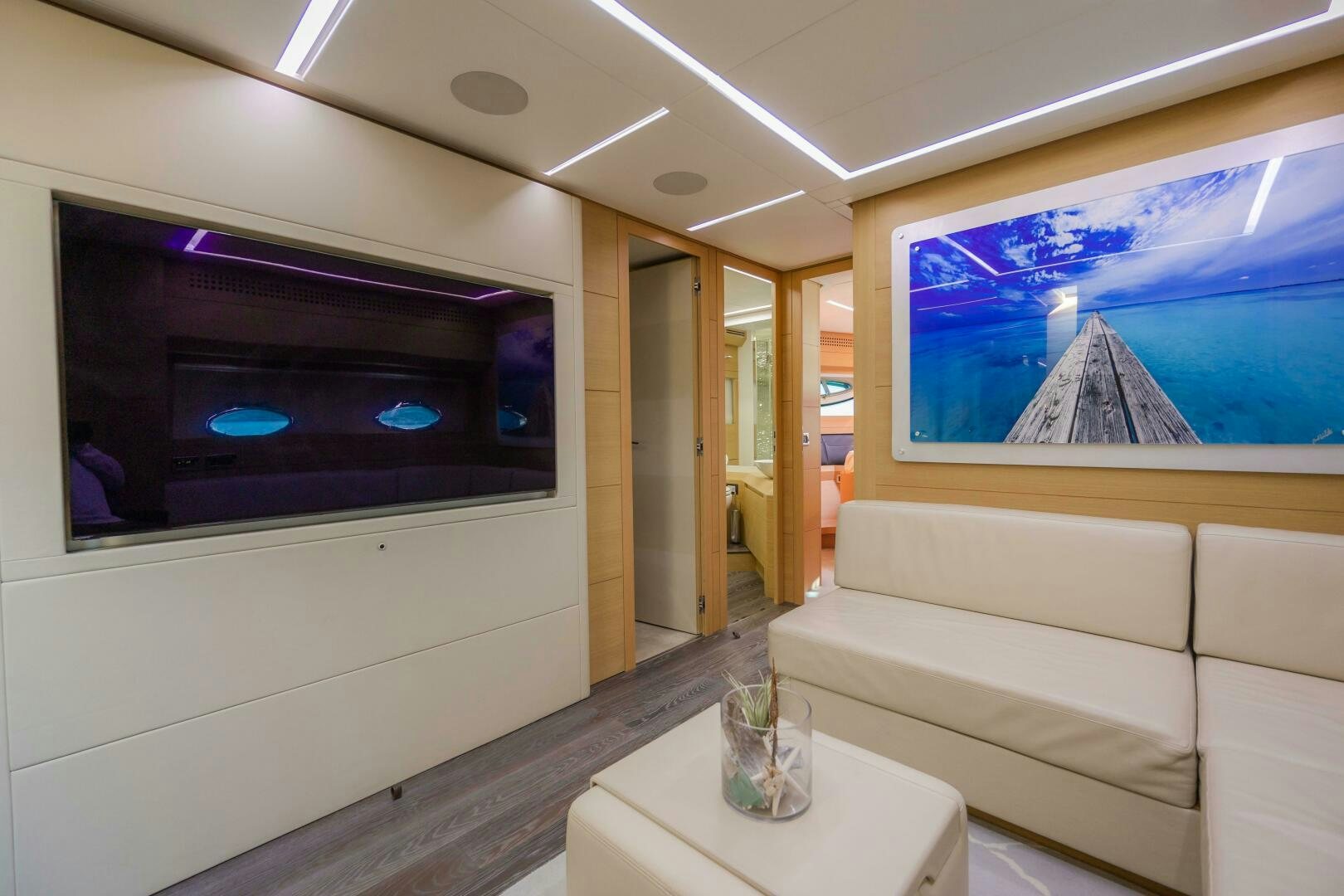 a living room with a large screen aboard MILAGROS Yacht for Sale