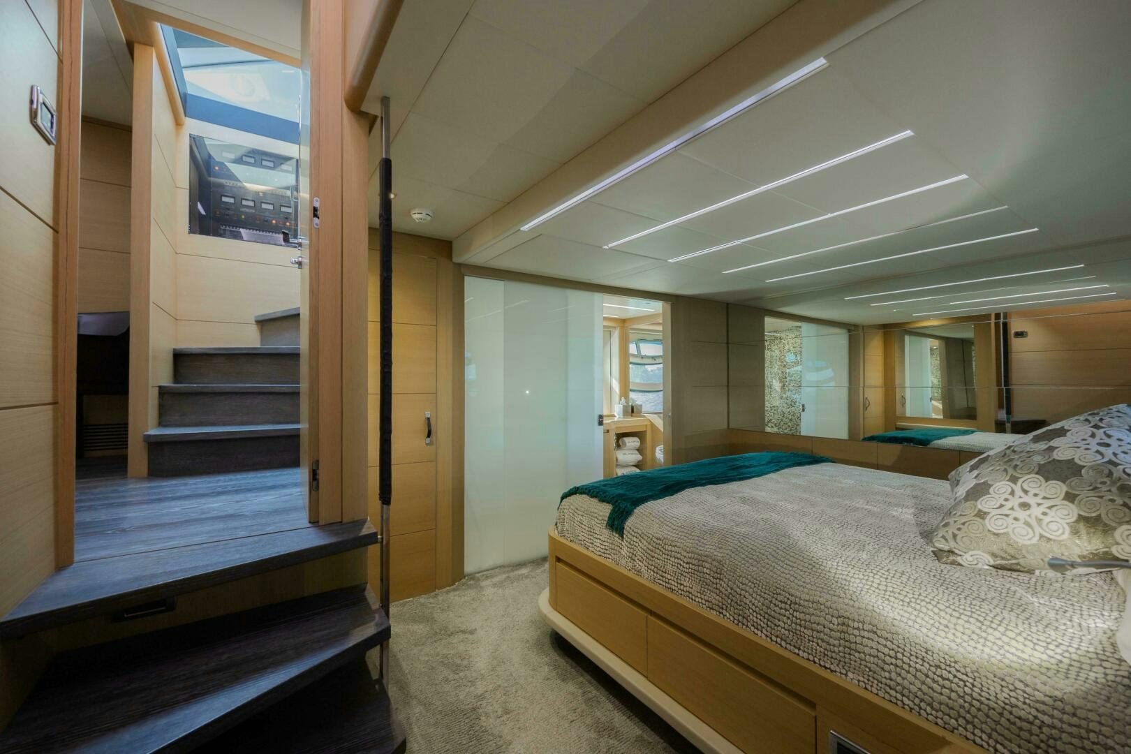 a bedroom with a bed and a staircase aboard MILAGROS Yacht for Sale