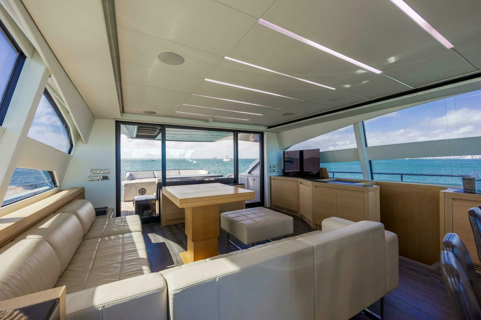 inside of a vehicle with a desk and chairs and a large window aboard MILAGROS Yacht for Sale