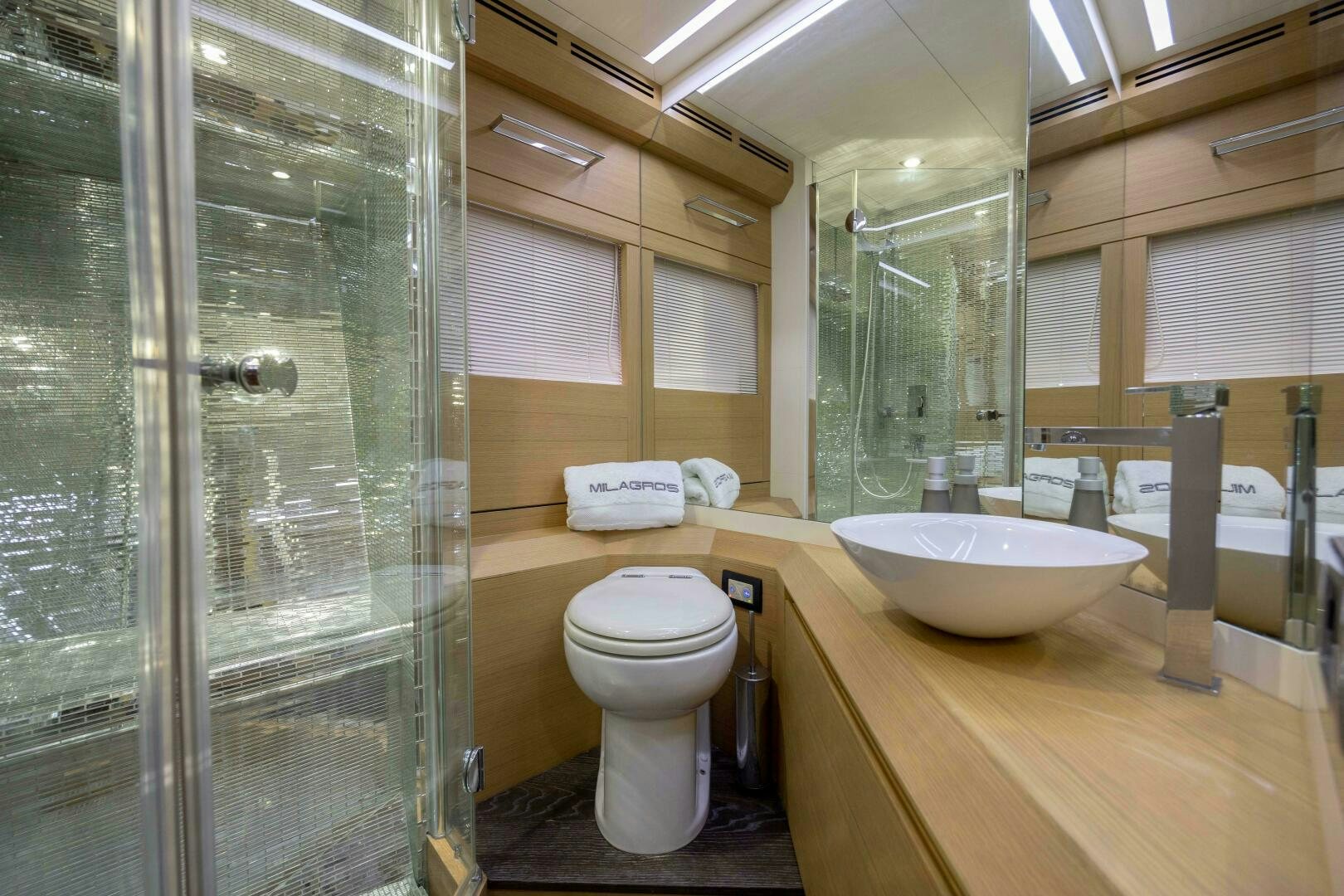 a bathroom with a glass shower aboard MILAGROS Yacht for Sale