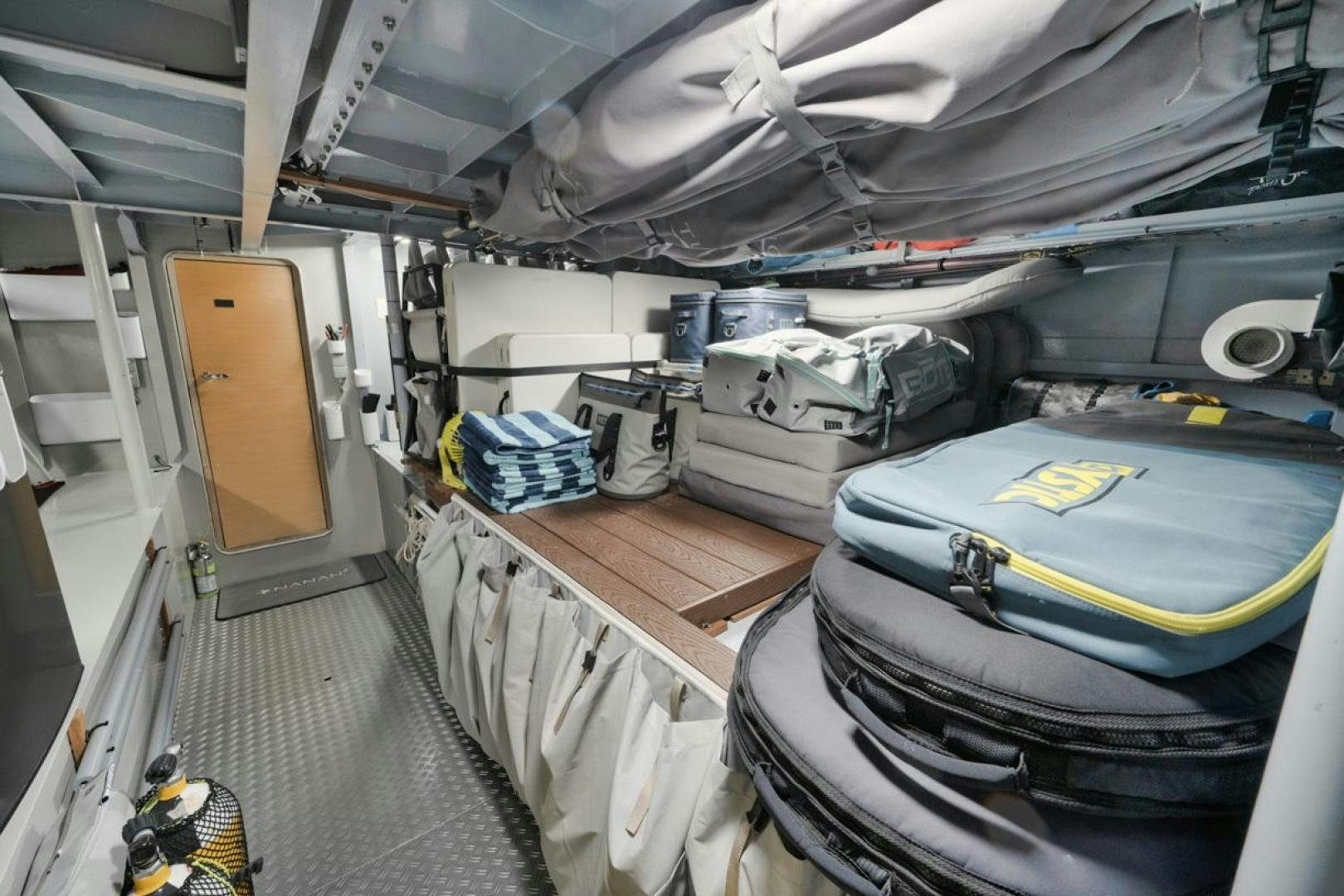 a large room with several luggage aboard NANAN SHADOW Yacht for Sale