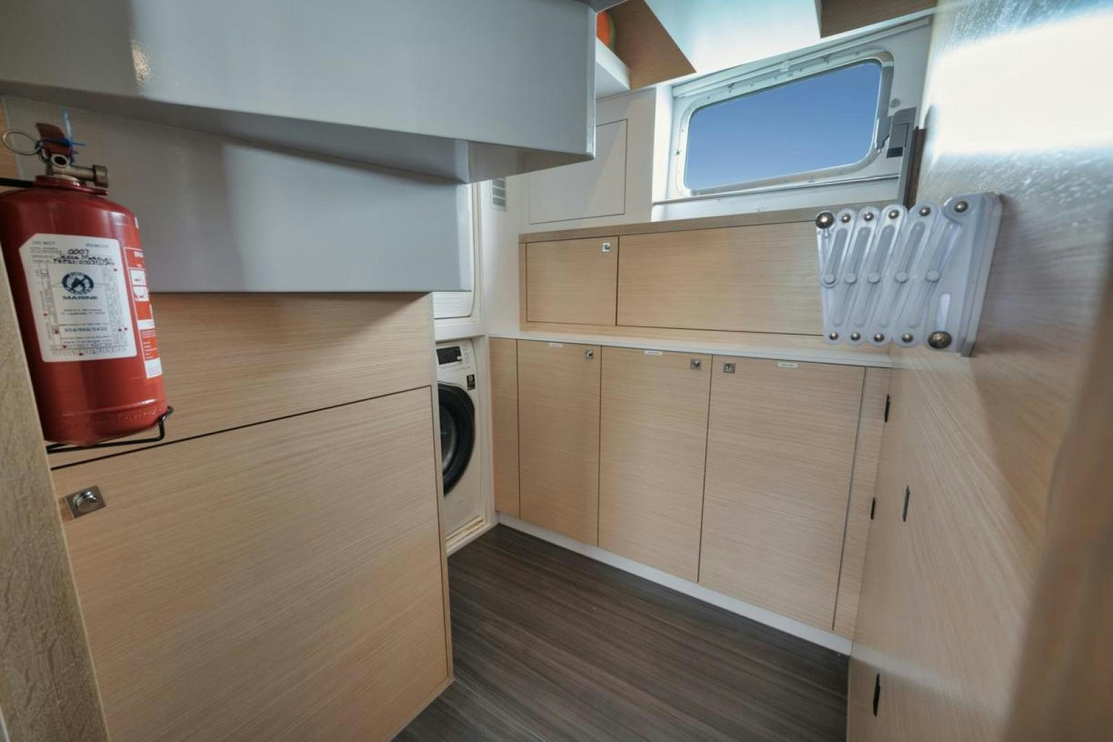 a kitchen with a microwave and a refrigerator aboard NANAN SHADOW Yacht for Sale
