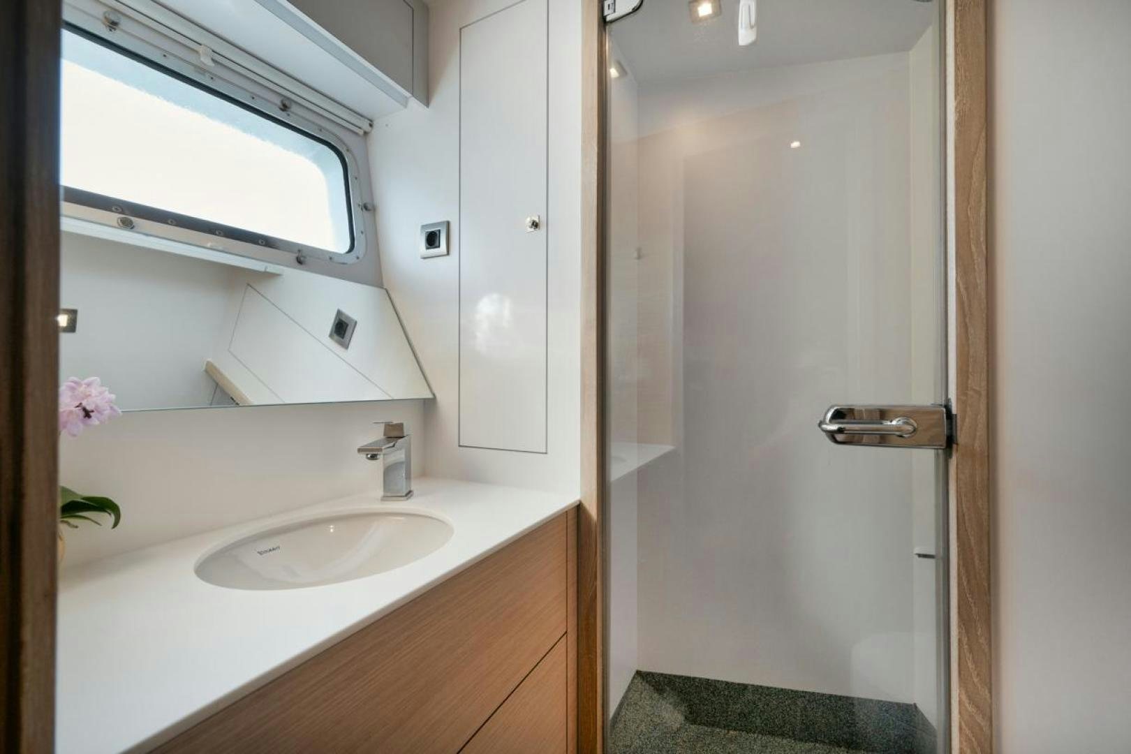 a bathroom with a sink and a mirror aboard NANAN SHADOW Yacht for Sale