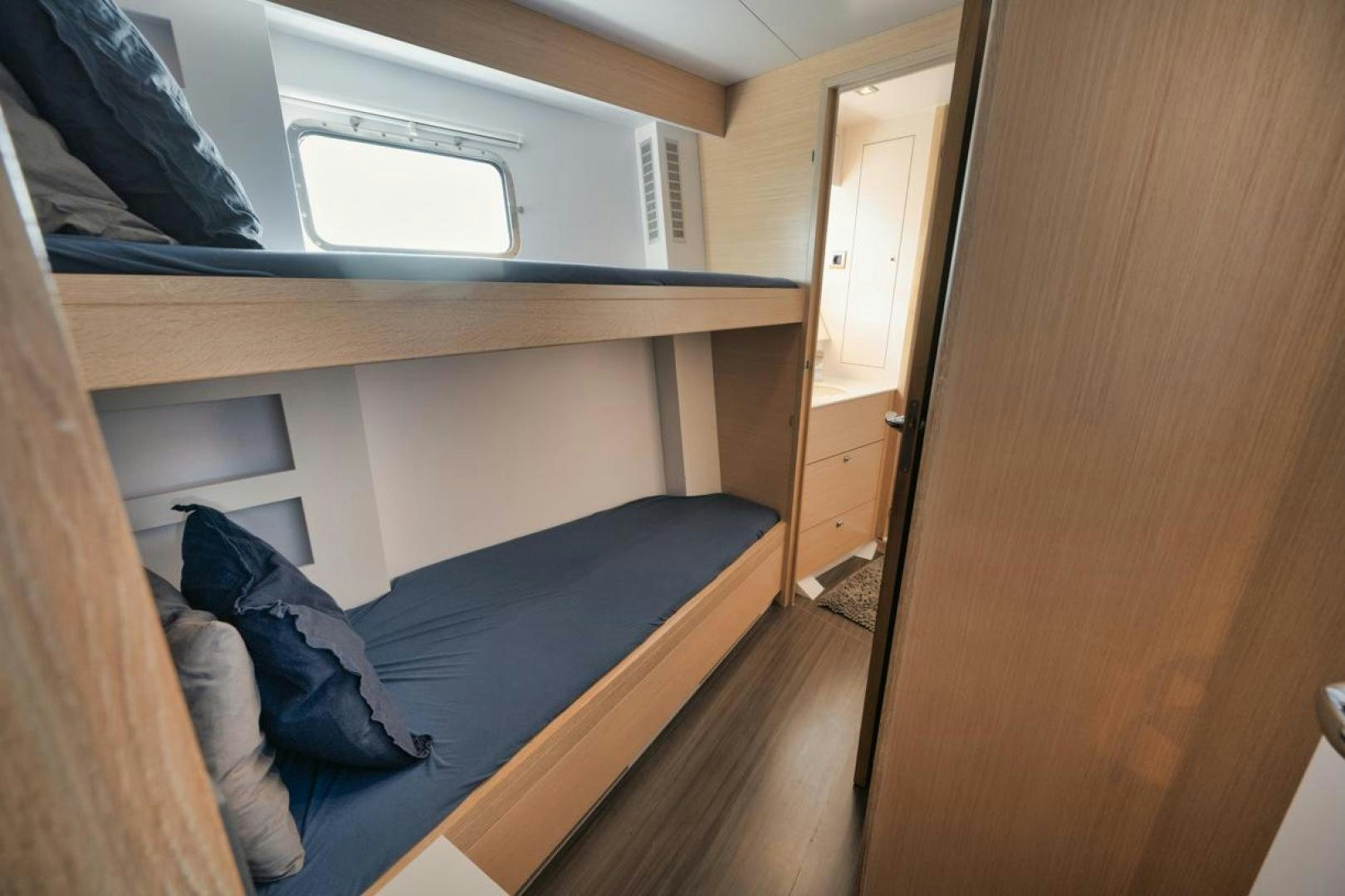 a room with a bed and a desk aboard NANAN SHADOW Yacht for Sale