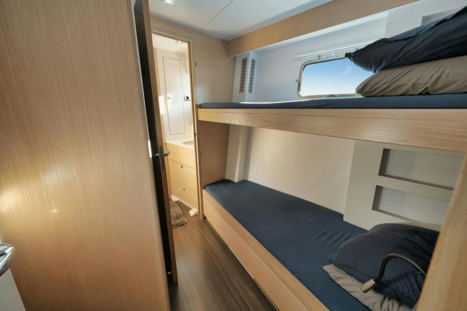 a room with a bed and a closet aboard NANAN SHADOW Yacht for Sale