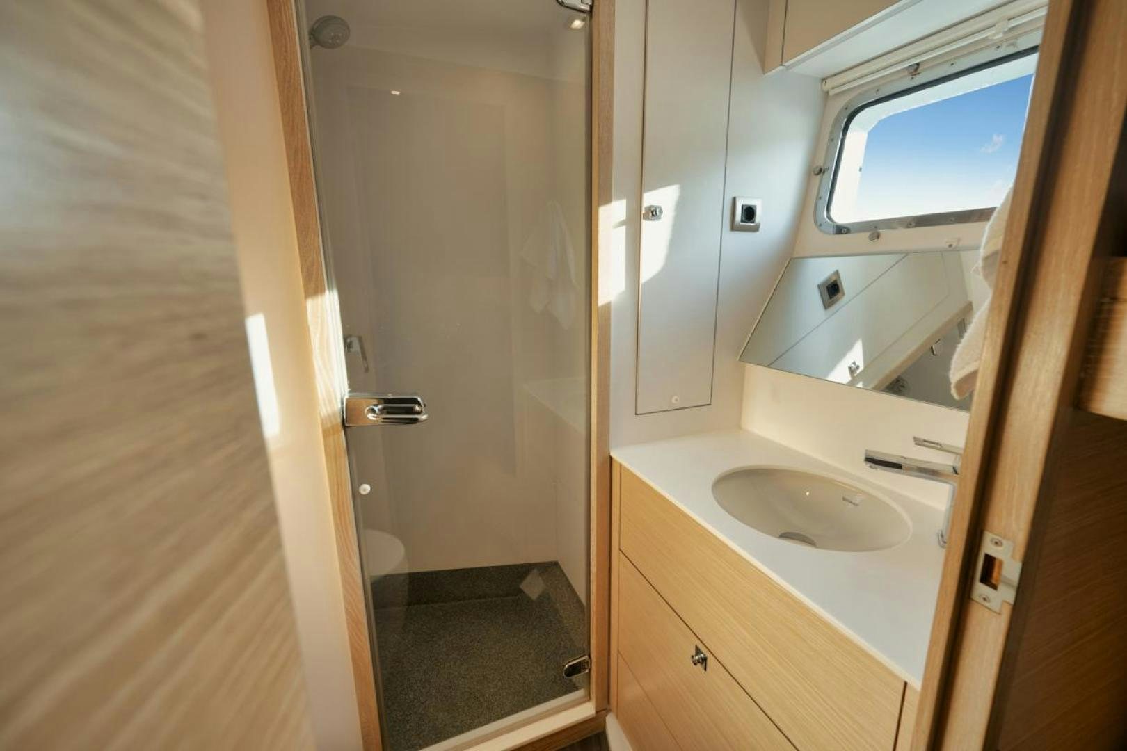 a bathroom with a sink and a mirror aboard NANAN SHADOW Yacht for Sale