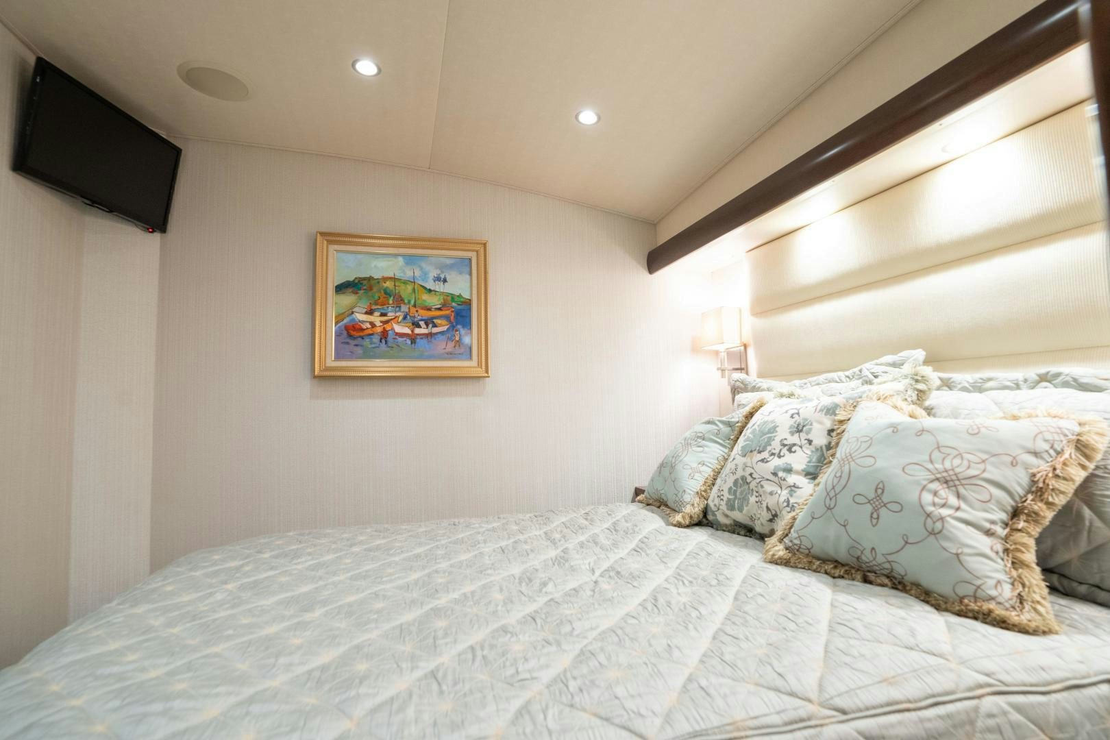 a bed with a white comforter aboard MER SEA SAKES Yacht for Sale