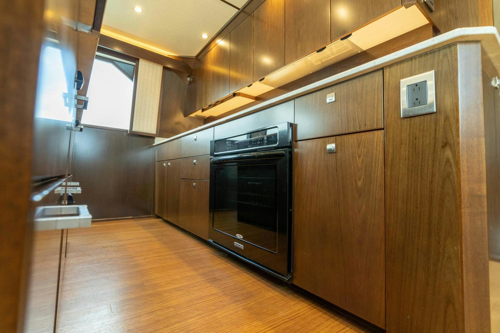 a kitchen with wooden cabinets aboard MER SEA SAKES Yacht for Sale