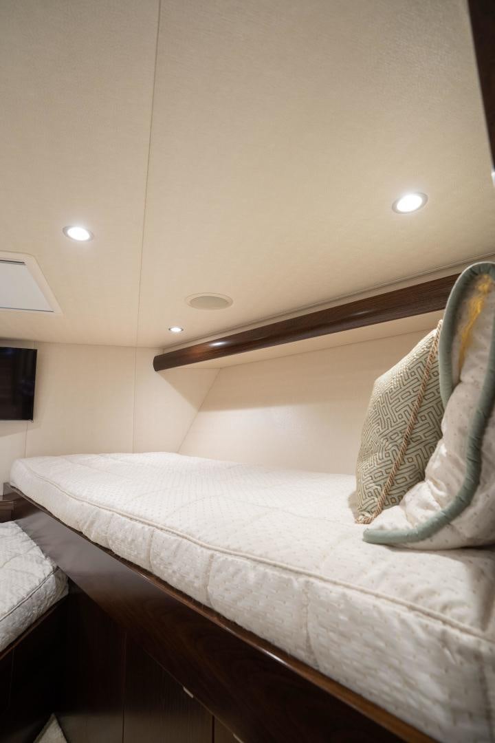 a bed with a white comforter aboard MER SEA SAKES Yacht for Sale