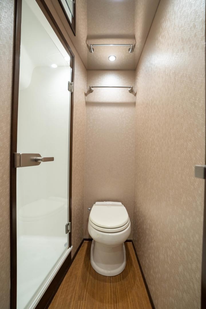 a bathroom with a toilet and a shower aboard MER SEA SAKES Yacht for Sale