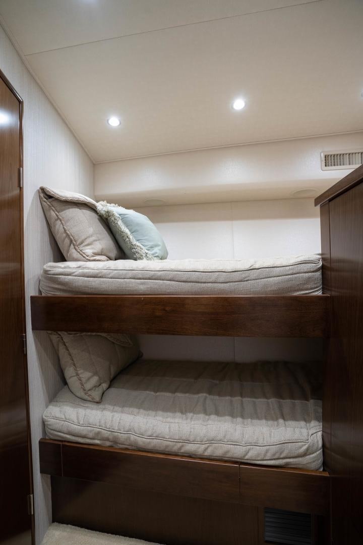 a bed with a white comforter aboard MER SEA SAKES Yacht for Sale